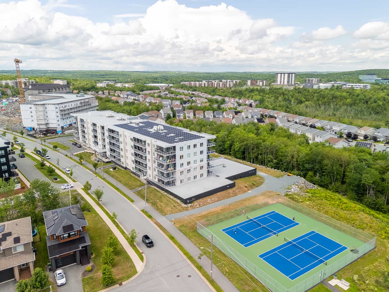 Aerial view of Greenfield Estates alongside the on-site tennis and pickleball courts