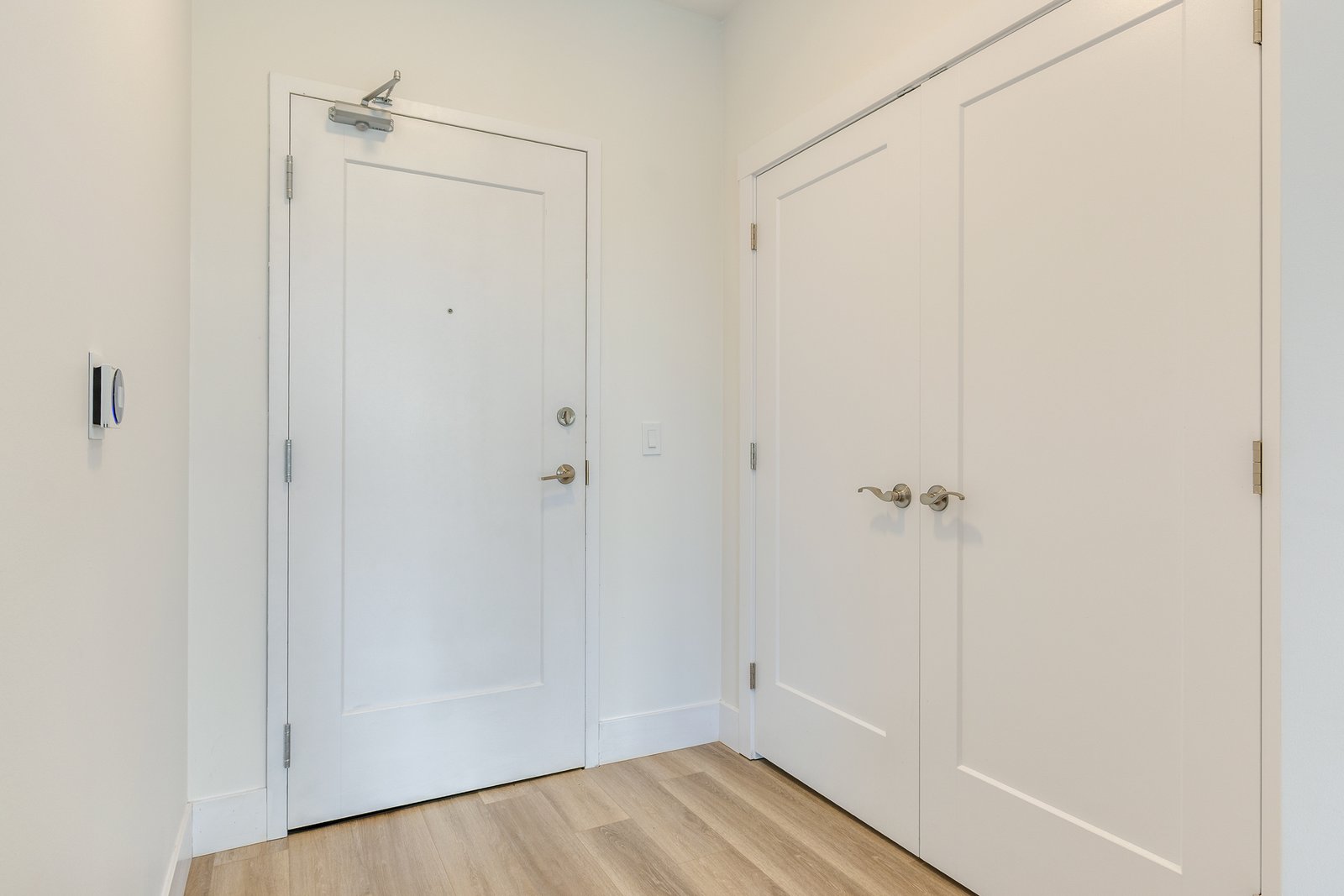 Unit entryway with the front door and double closets