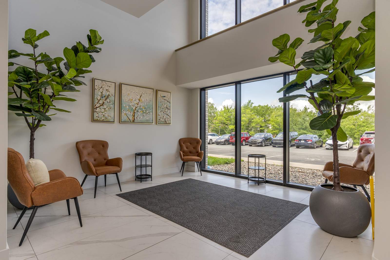Ground-floor lobby seating area with tall windows onto the parking court